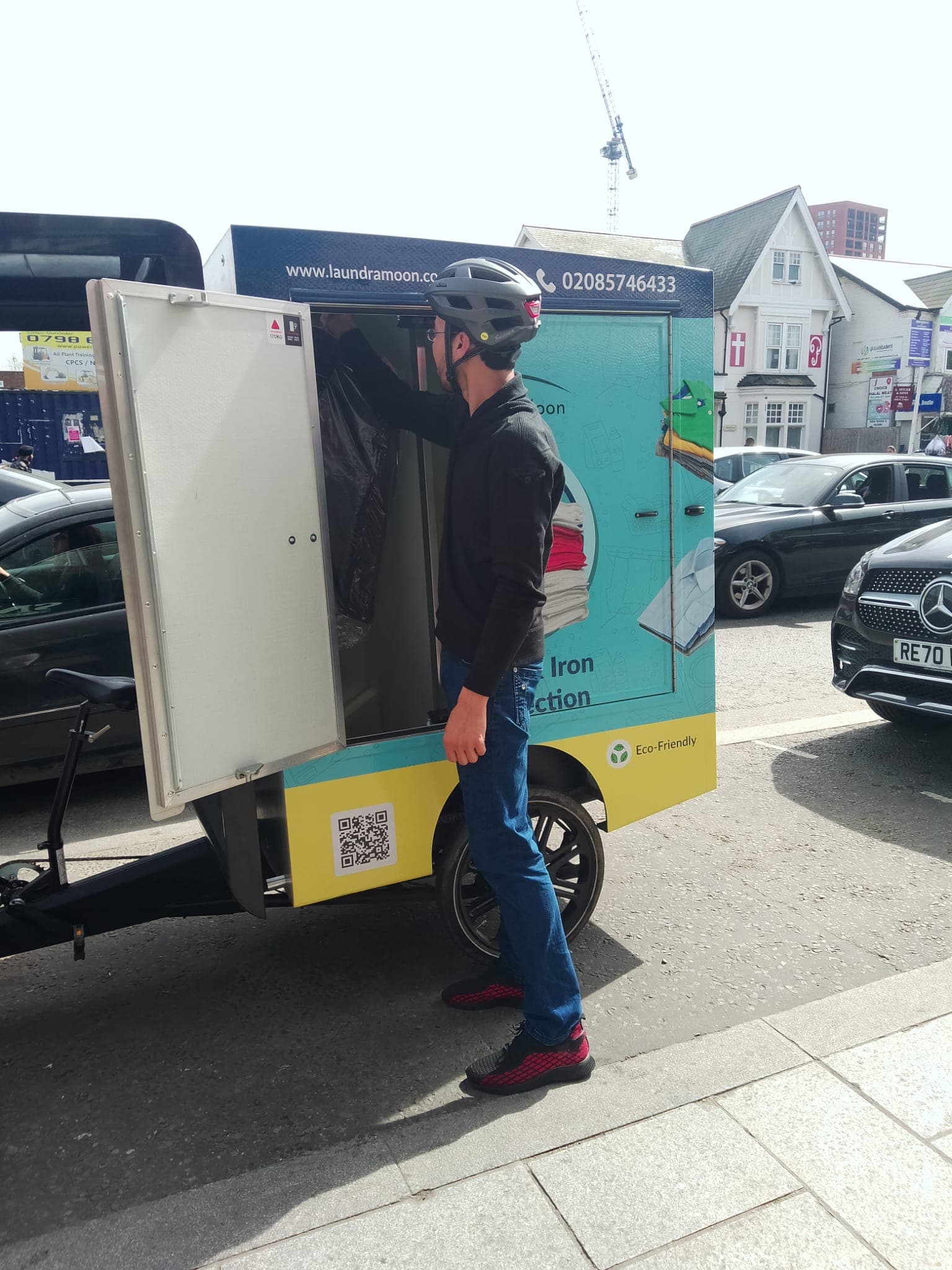 A laundry man delivering clothes on a E bike, Ecofriendly solution